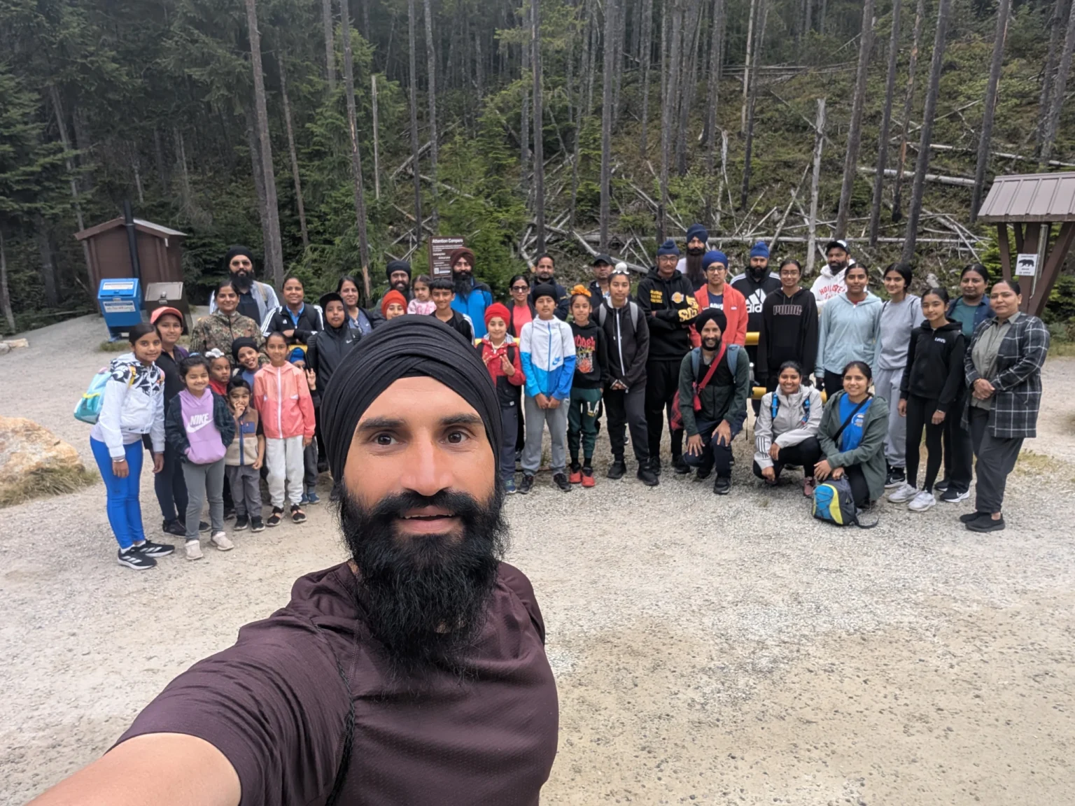 Group photo beside ancient cedar stump