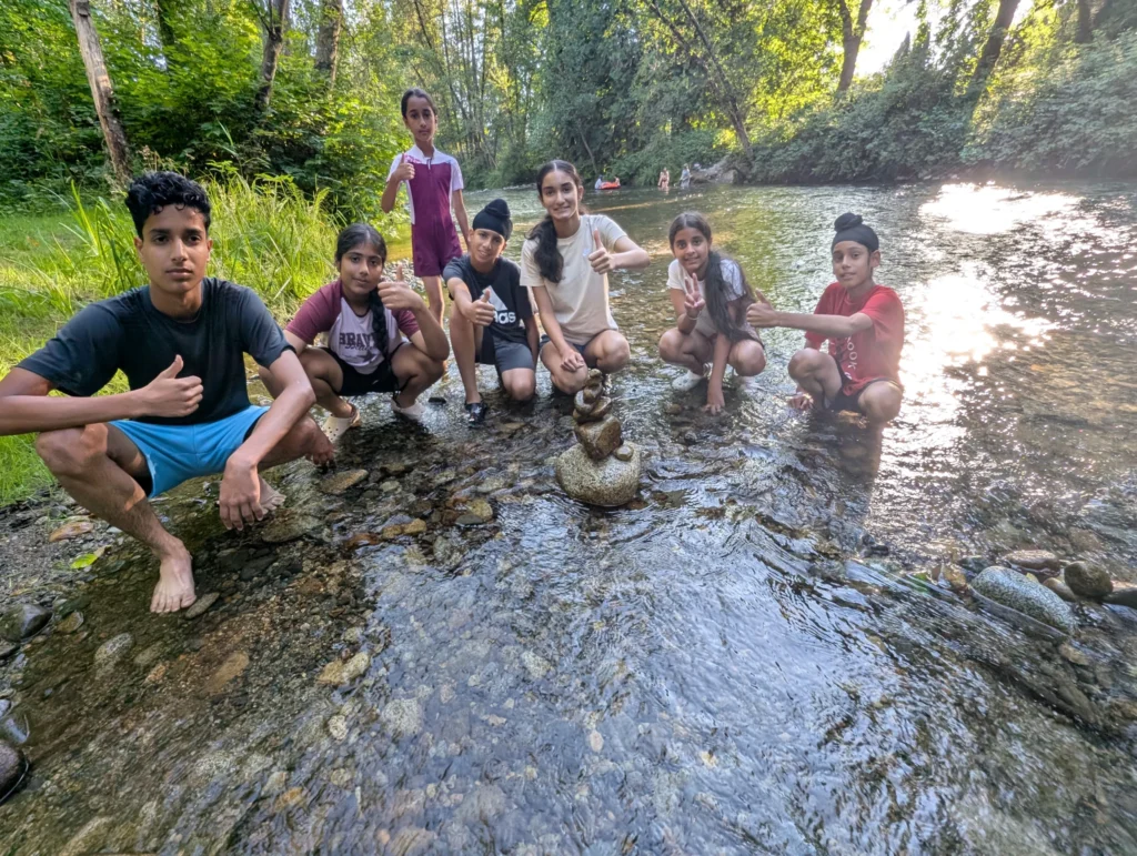 Athletes trekking along forest trail
