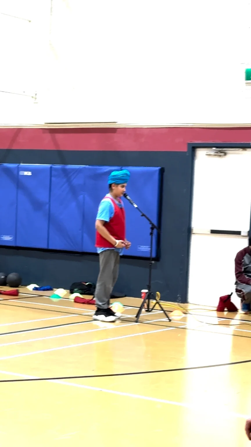 Senior coach and athlete addressing gathering
