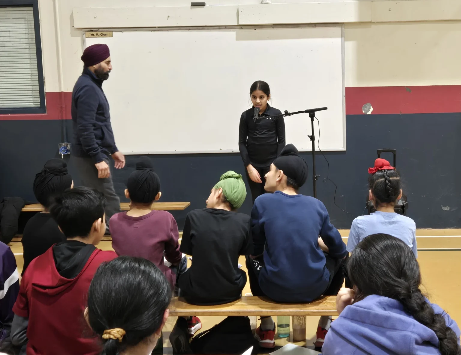 Players presenting on stage to parents and community